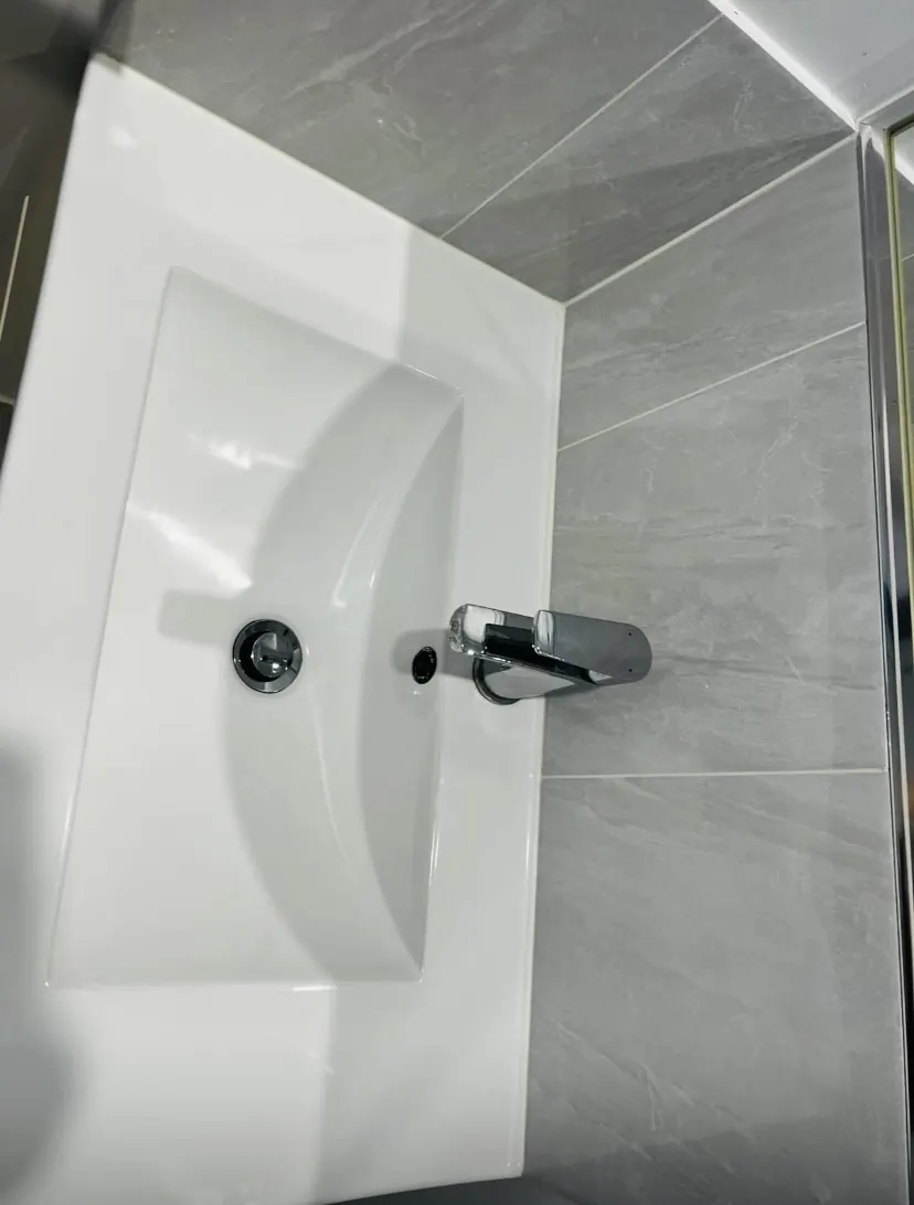 The same basin and tap polished to a clean, mirror-bright shine after cleaning