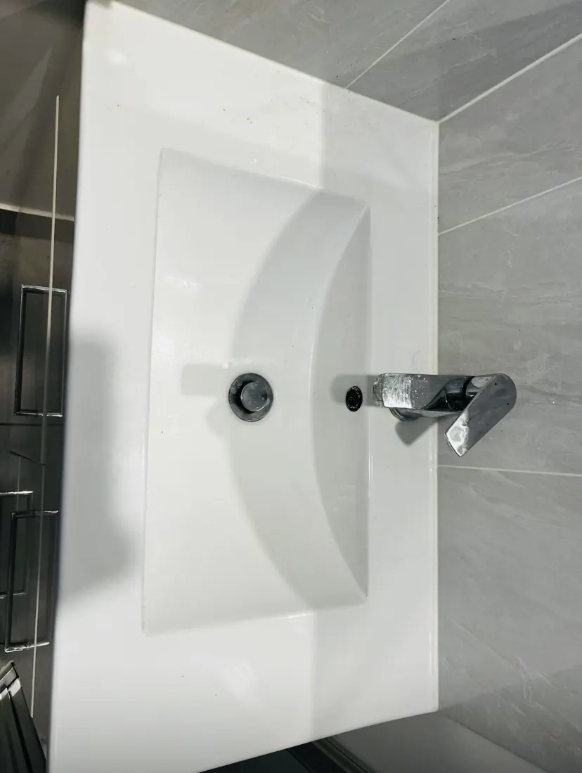 Bathroom basin and tap dulled by water marks and build-up before cleaning
